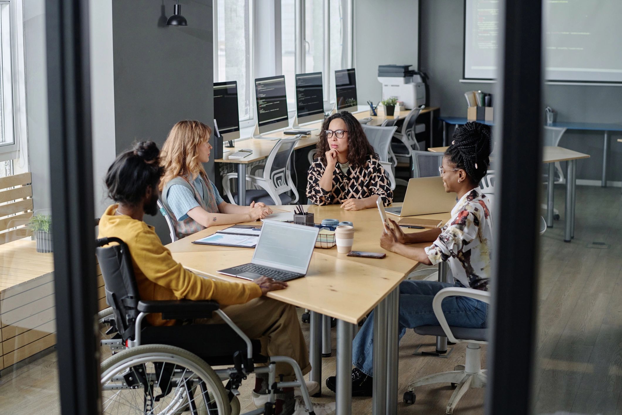 Diverse team collaborating around a desk in a modern office